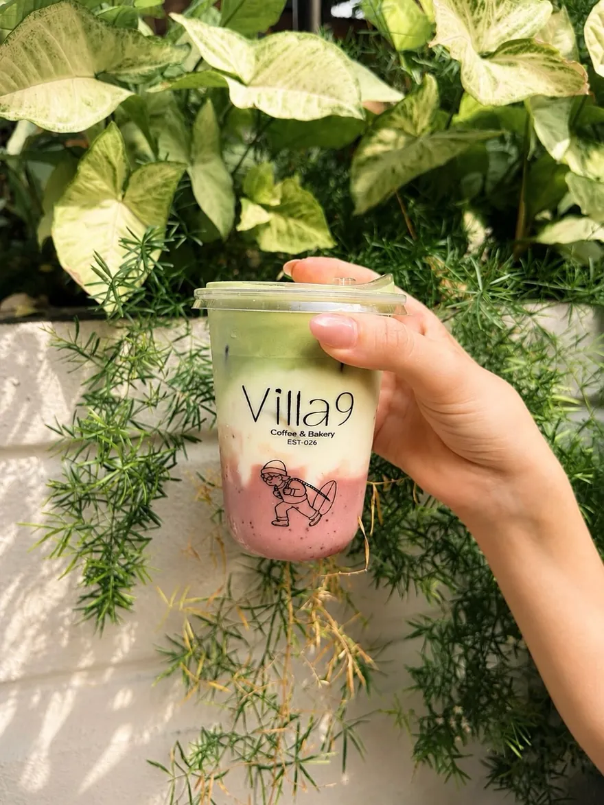 An iced strawberry matcha, pink at the bottom and green on top.